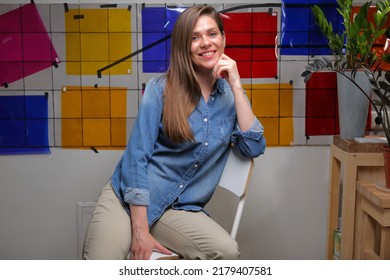 Smiling Woman Designer Student In Classroom With Color Palette Sitting On Chair.