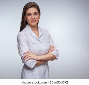 Smiling woman doctor wearing white medical uniform standing with crossed arms. isolated portrait of young nurse.