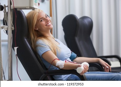 Smiling Woman Donating Blood In Hospital