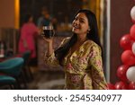 Smiling woman drinking coke at restaurant