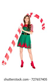 Smiling Woman In Elf Costume Holding Decorative Christmas Lollipop Isolated On White