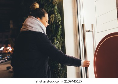 Smiling Woman Enters Store Opens The Door On Winter Evening