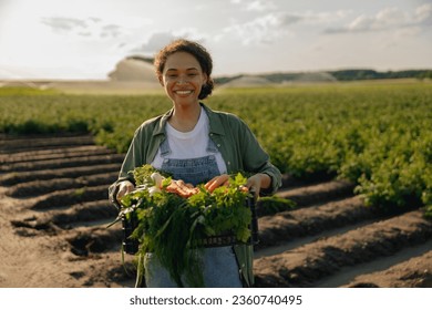 Smiling woman farmer with just harvested vegetables basket ready to sale. Agricultural concept - Powered by Shutterstock