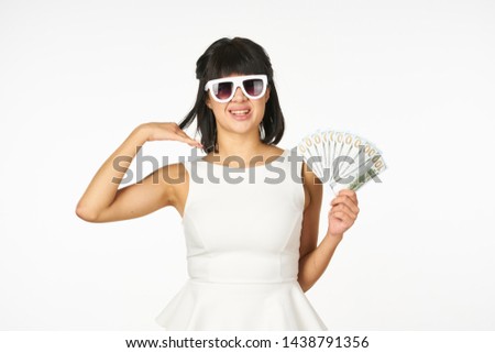    smiling woman with glasses holds money in her hands                            