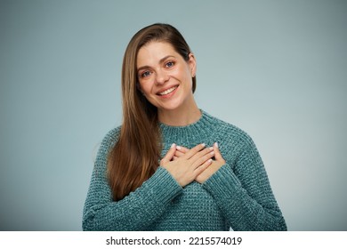 Smiling Woman In Green Sweater Holding Two Hands On Chest. Advertising Female Studio Portrait.