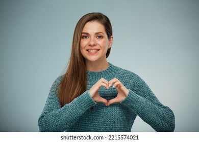 Smiling Woman In Green Sweater Holding Two Hands On Chest With Heart Shape Figure.