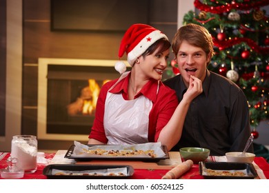 Smiling Woman Handing Christmas Cake To Man For Tasting.?