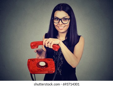 Smiling Woman Hanging Up An Old Phone