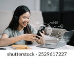 Smiling woman in headphones taking notes, motivated interested student studying online, using tablet, watching webinar training or listening to lecture, remote education concept.