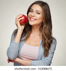smiling woman with healthy teeth holding red apple. studio isolated portrait.