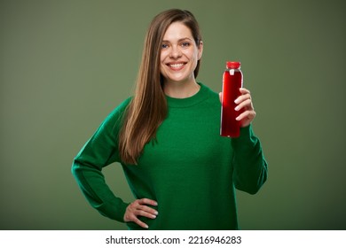 Smiling Woman Holding Bottle With Red Drink. Isolated Advertising Portrait On Green.