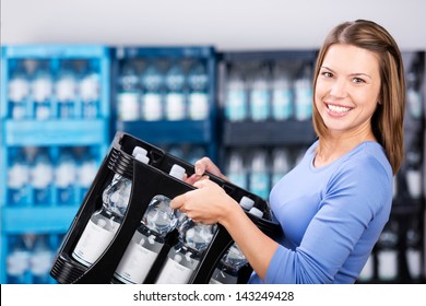 Smiling woman holding a box of refundable bottles