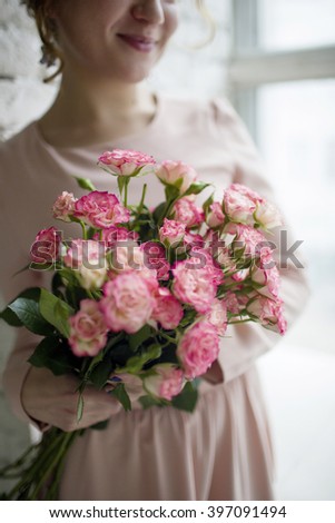 Similar – Woman makes festive bouquet with vase