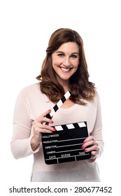 Smiling woman holding open clapper board