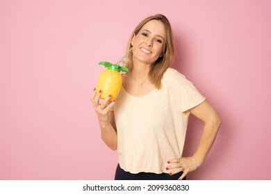 Smiling Woman Holding Pinapple Juice Standing Isolated Over Pink Background.