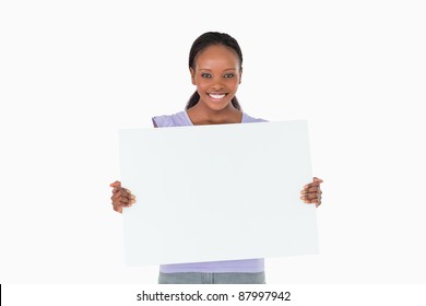 Smiling woman holding placeholder in her hands on white background