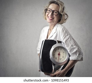 Smiling Woman Holding A Scale
