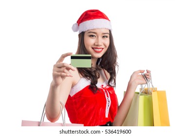 Smiling woman holding shopping bags before christmas showing credit card. Focus on card.