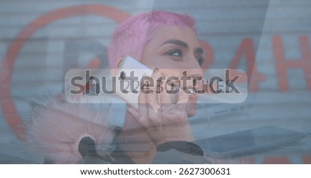 Smiling woman holding smartphone outside closed storefront shutter, displaying like counter overlay. Urban, technology, socialmedia, communication, vibrant, youthful, modern