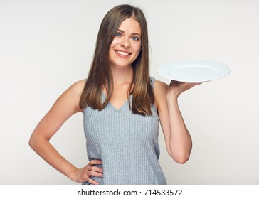 Smiling Woman Holding White Empty Plate. Isolated Studio Portrait.