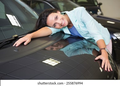 Smiling Woman Hugging A Black Car At New Car Showroom