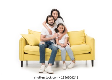 Smiling Woman Hugging Family On Yellow Sofa Isolated On White
