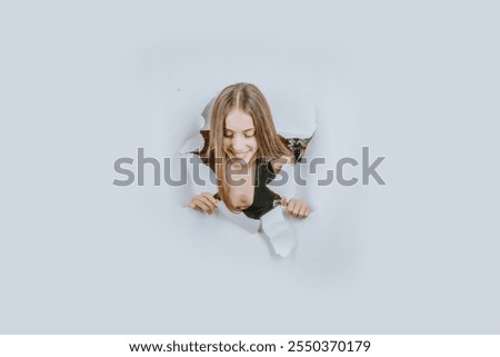Similar – Image, Stock Photo Woman peeking through Christmas wrapping paper, festive mood