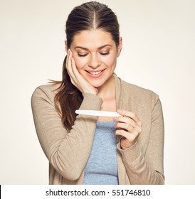 Smiling Woman Looking On Pregnant Test. Isolated Portrait Of Young Expectant Mother.