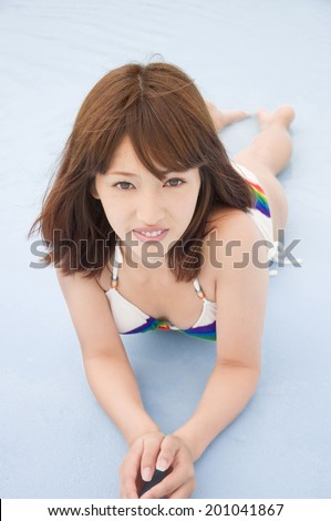 smiling woman lying with a swimsuit