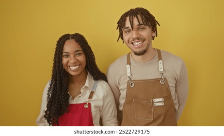 Smiling woman and man in aprons against a yellow background, implying a cheerful team in a flower shop. - Powered by Shutterstock