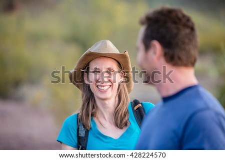 Smiling woman with man out for a nature hike