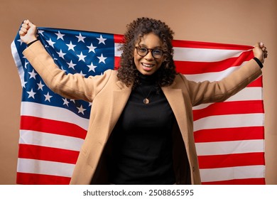 Smiling woman with national USA flag on beige background. American patriot, 4th of July - Independence day celebration, election, America, labor. US banner. High quality - Powered by Shutterstock