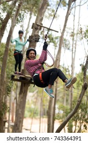 Smiling Woman On Zipline In Adventure Park