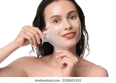 Smiling woman peeling off face mask on white background - Powered by Shutterstock