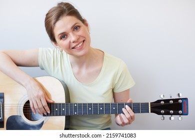 Smiling Woman Play On Guitar. Isolated Portrait On Gray Back.