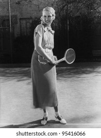 Smiling woman playing tennis