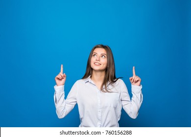 Smiling Woman Pointing Finger Up Over Blue Background