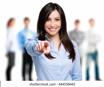 Smiling woman pointing her finger to you