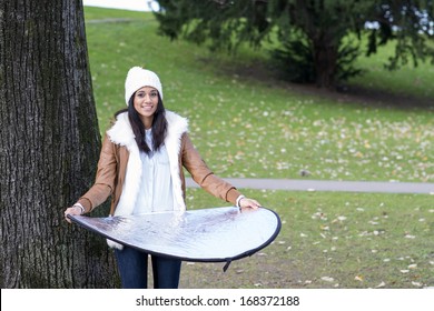 Smiling Woman Posing At Camera And Holding Reflector, Outdoor.