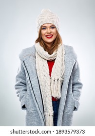 Smiling Woman Posing In Wool Winter Coat Wearing Knitted Hat And Scarf. Isolated Woman Portrait In Winter Coat