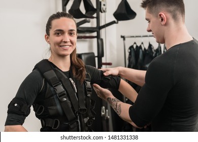 Smiling woman preparing for EMS training and wearing vest