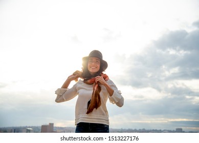 Smiling Woman With Scarf On Her Neck And Hat