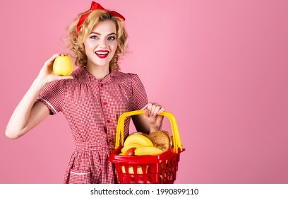 Smiling Woman With Shopping Basket And Apple In Hand. Happy Girl On Supermarket. Buying Spree. Female With Shopping Cart.