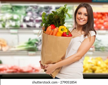 Smiling woman shopping in a supermarket