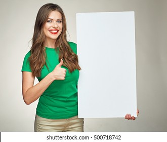 smiling woman show thumb up with big sign board. isolated portrait on gray background.