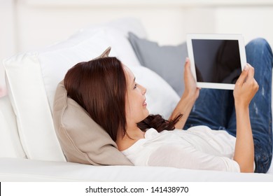 Smiling woman sitting thinking in an office chair as she mulls over a new idea in her mind - Powered by Shutterstock