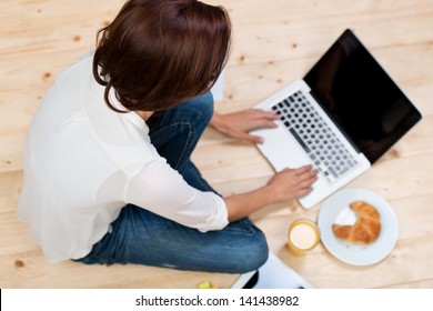 Smiling woman sitting thinking in an office chair as she mulls over a new idea in her mind - Powered by Shutterstock