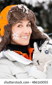 Smiling Woman In The Snow With A Small Sun Drawing On The Cheek