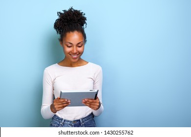 Smiling  Woman Standing With Ipad Looking At The Screen And Happily Smile