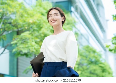 A Smiling Woman Standing In The Office District